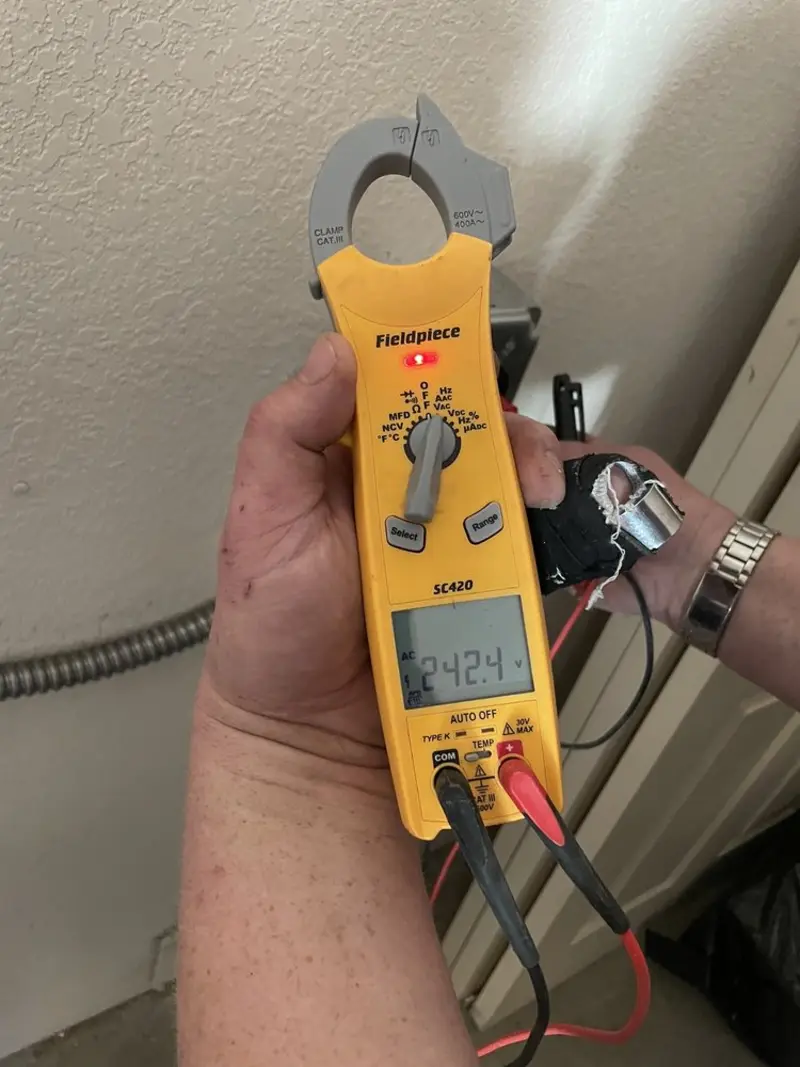 Voltage testing with clamp meter during Outlet Installation in Selah